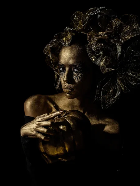Golden woman with halloween pumpkin — Stock Photo, Image