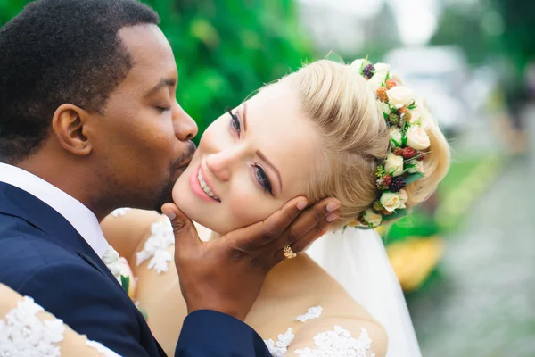 Groom kisses face of bride — Stock Photo, Image