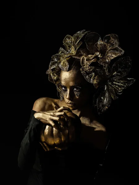 Golden woman with halloween pumpkin — Stock Photo, Image