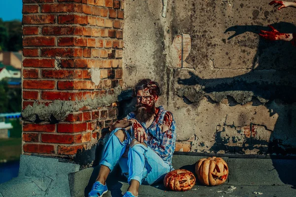 Zombie man with halloween pumpkins — Stock Photo, Image