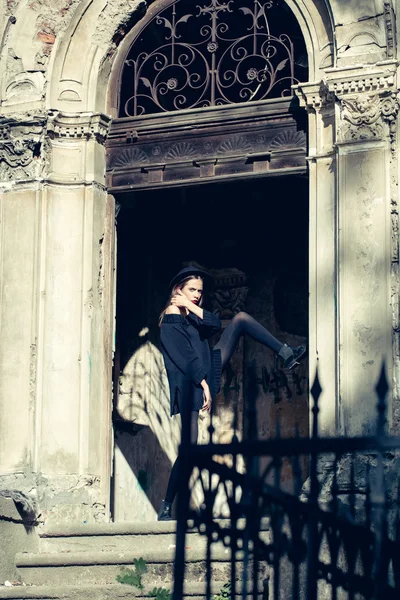 fashionable woman near old building