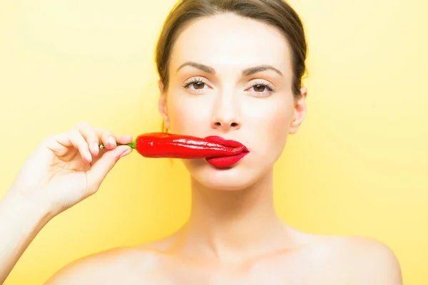 Girl with red chilli pepper Stock Image