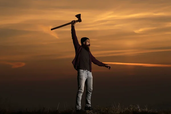 Man with axe on sunset — Stock Photo, Image