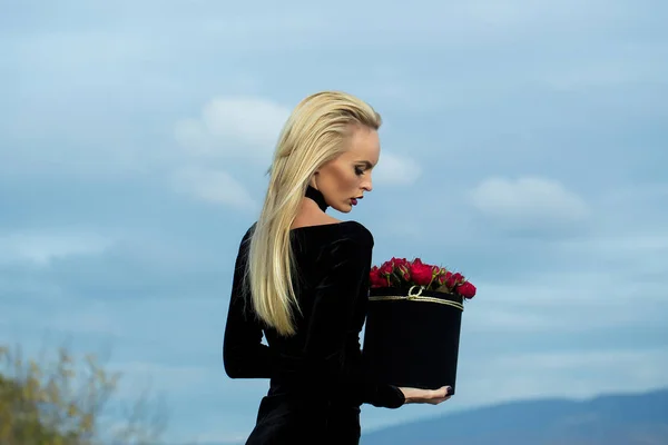 Pretty girl with flowers in box