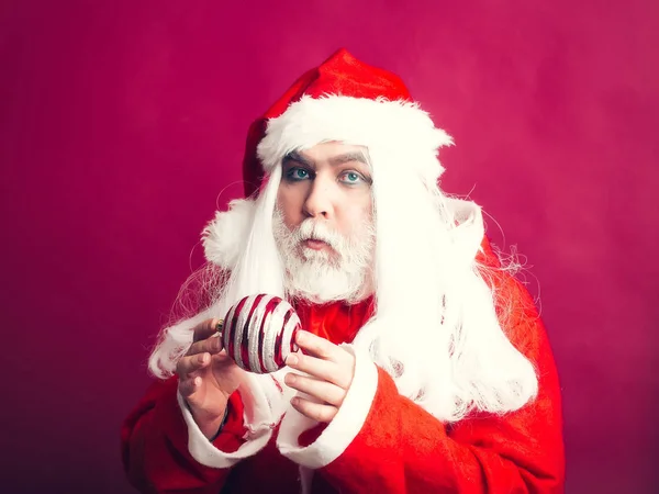 Serious Christmas man with decorative ball — Stock Photo, Image