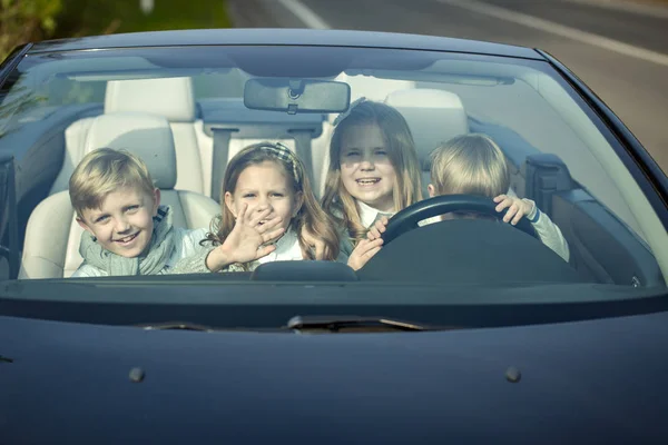 Happy children friends in car — Stock Photo, Image