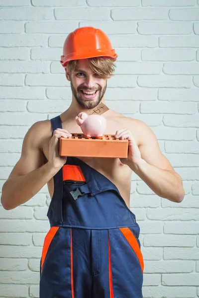 sexy muscular man builder with moneybox