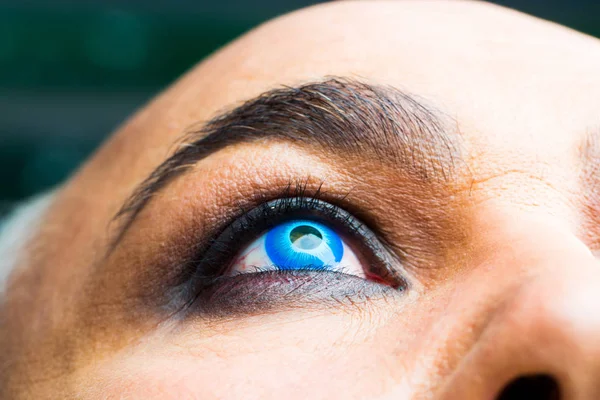 Male eye with blue lens — Stock Photo, Image