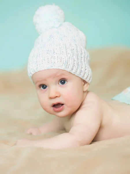 Cute baby in white knitted hat — Stock Photo, Image