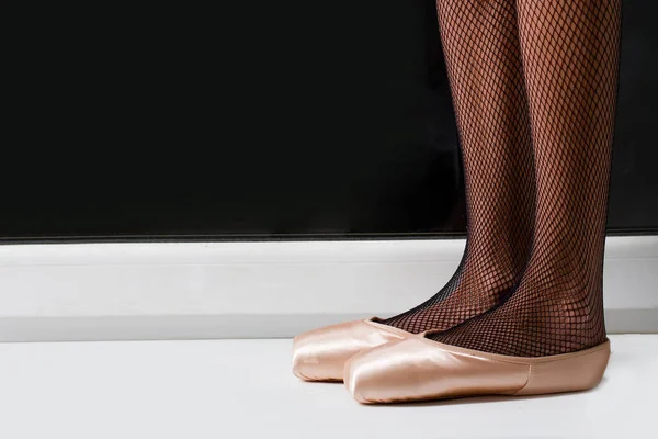 Female legs in ballet shoes