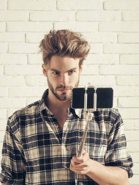 Komea mies käyttää selfie tikku — kuvapankkivalokuva