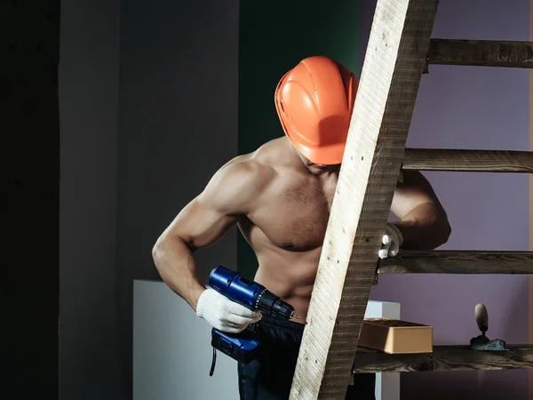 sexy muscular man builder on ladder