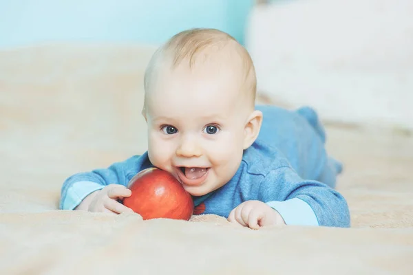 Little happy baby with red apple — Stock Photo, Image