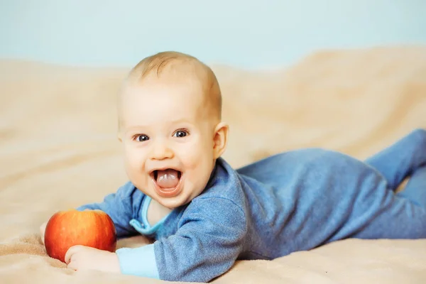 Little happy baby with red apple — Stock Photo, Image