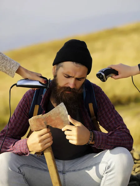 Bearded man hipster with axe