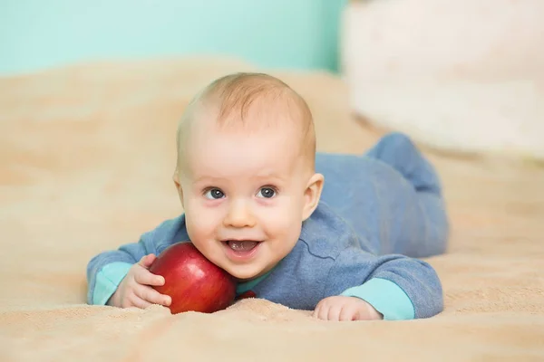 Little happy baby with red apple — Stock Photo, Image