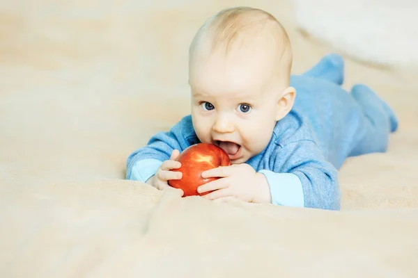 Little boy bites red apple — Stock Photo, Image