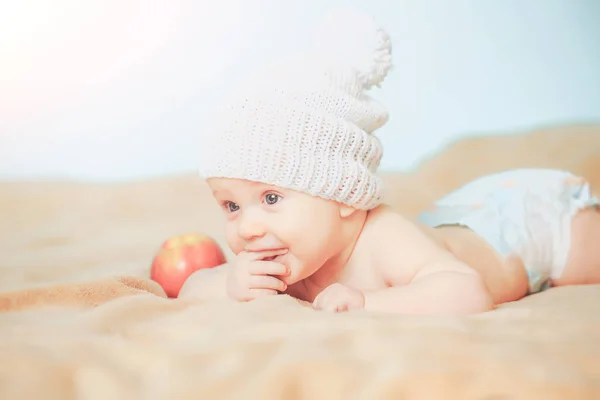 Little hungry baby boy with red apple — Stock Photo, Image