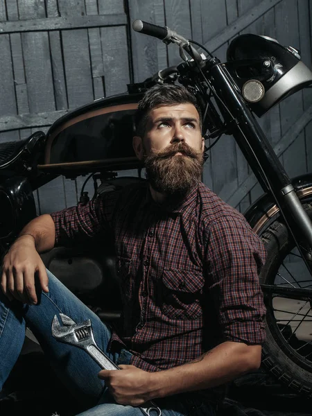 Bearded biker man with wrench — Stock Photo, Image