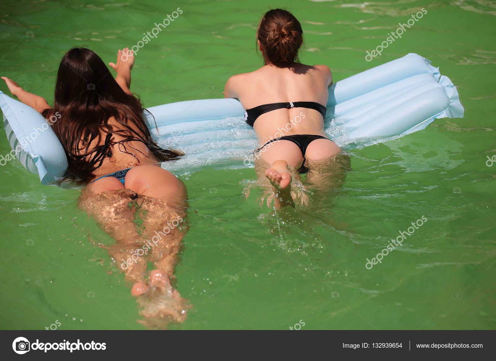 Pretty sexy girls in pool Stock Photo by ©Tverdohlib.com 132939654