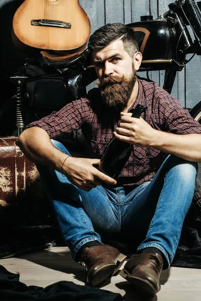 Bearded biker man with bottle — Stock Photo, Image