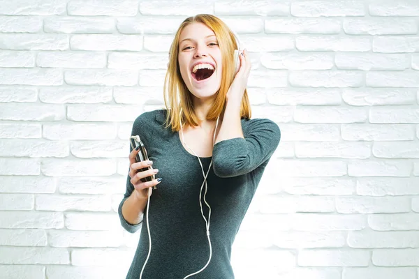 Happy girl listens to music