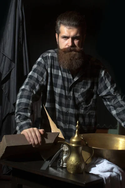 Bearded man with barber tools