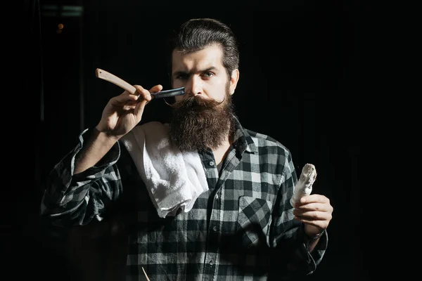 Бородач бреется бритвой. — стоковое фото