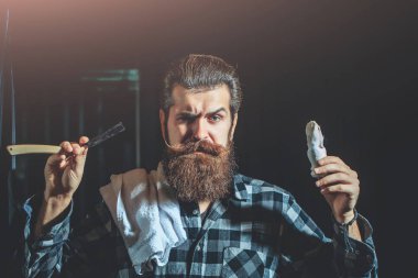 Bearded man shaves with razor clipart