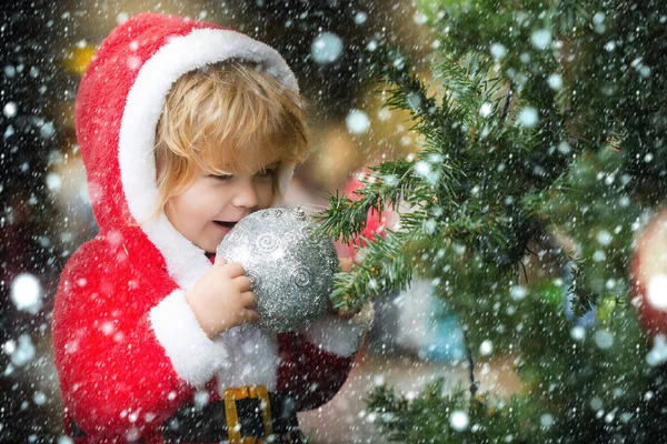 Santa boy with decorated tree — Stock Photo, Image