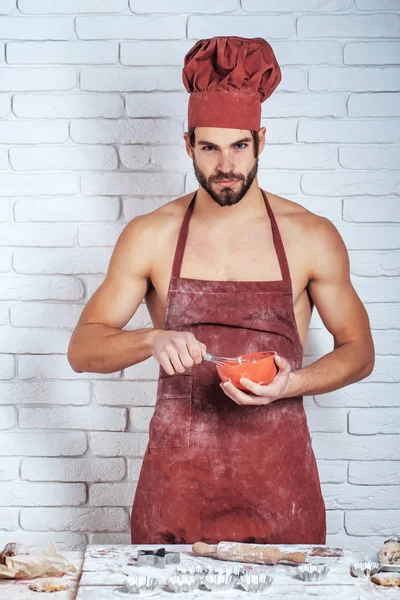 Muscular cook beats dough — Stock Photo, Image