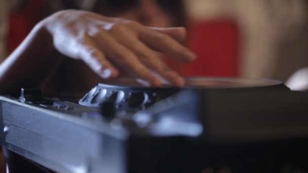 Sexy woman in headphones and sunglasses lying with dj equipment and playing music. Pretty young disc jockey girl dj mixer on table — Stock Video