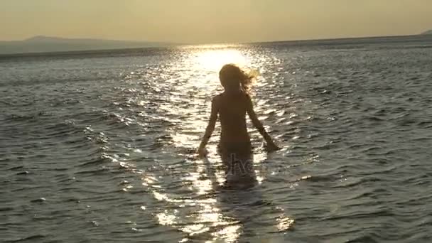 Vrolijke meisje met water aan de zee op het moment van de dag, vreugde sexy vrouw speelde op een rust — Stockvideo