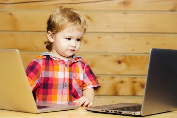 Bonito menino joga em computadores — Fotografia de Stock