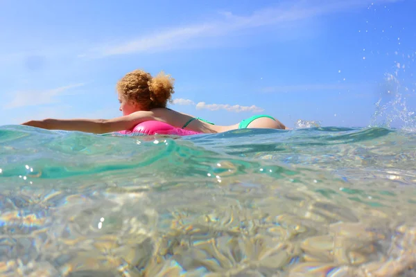 Cute woman swims on rubber ring. — Stock Photo, Image