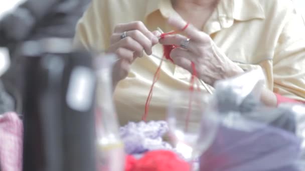 Talented hand knitting needles and orange thread — Stock Video