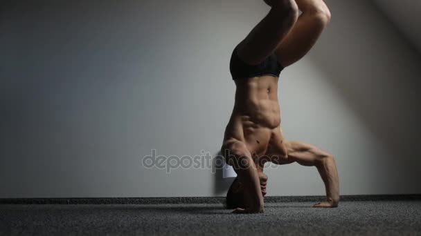 Athlete stands on his head and trains the body — Stock Video