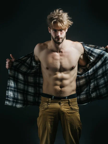 Sexy man takes shirt off