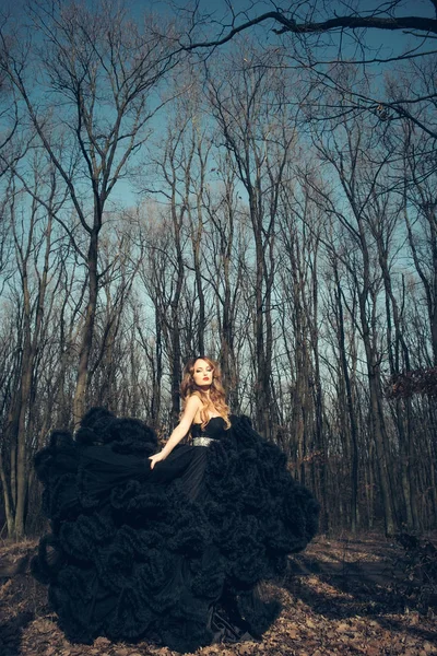 elegant young woman in forest