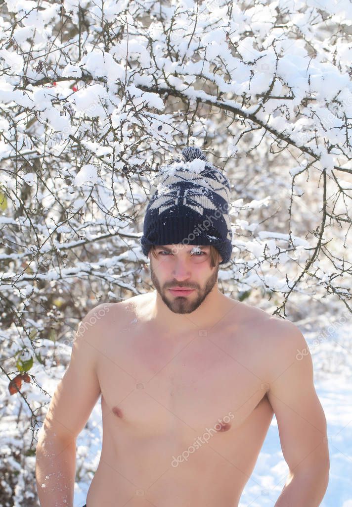 happy muscular man in winter forest