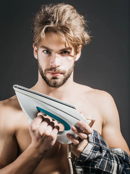 Sexy naked man holds iron — Stock Photo, Image