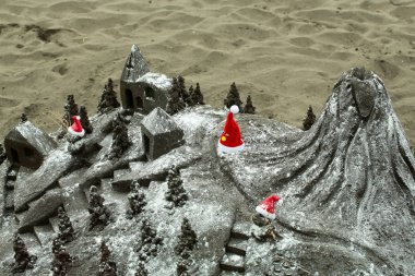 Güzel sandcastle veya kum heykel kırmızı santa şapkalar ile