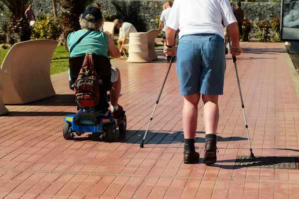 Disabled men walk on promenade — Stock Photo, Image