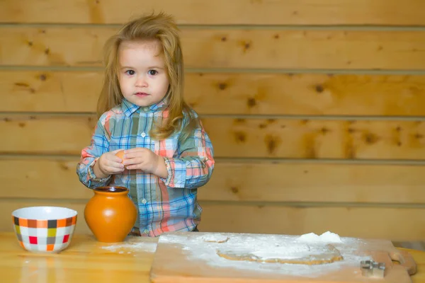 Cute child cooking with dough, flour, egg and bowl — Stock Photo, Image