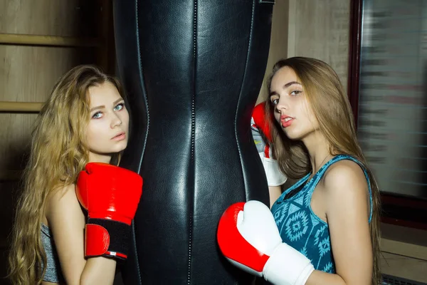 Two pretty girls boxers punching