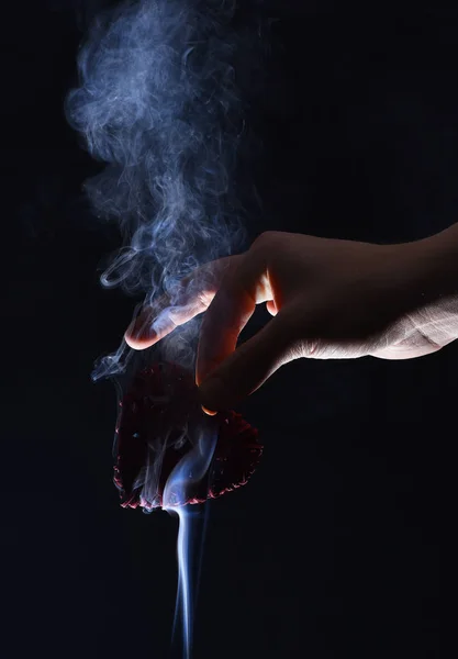 Male hand with decorative valentines day red heart in smoke — Stock Photo, Image