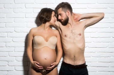 ince yuvarlak karın ile oldukça hamile kadın ve sakallı