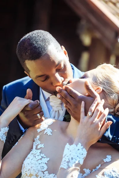 Loving groom kissing lips of adorable bride