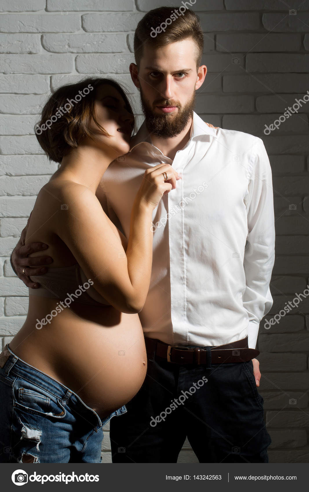 Bearded man and pretty pregnant woman with naked round belly Stock Photo by ©Tverdohlib 143242563