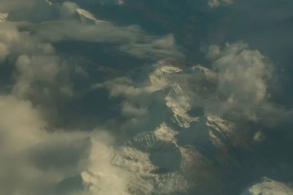 Pics de montagne enneigés idylliques sous les nuages de l'avion — Photo